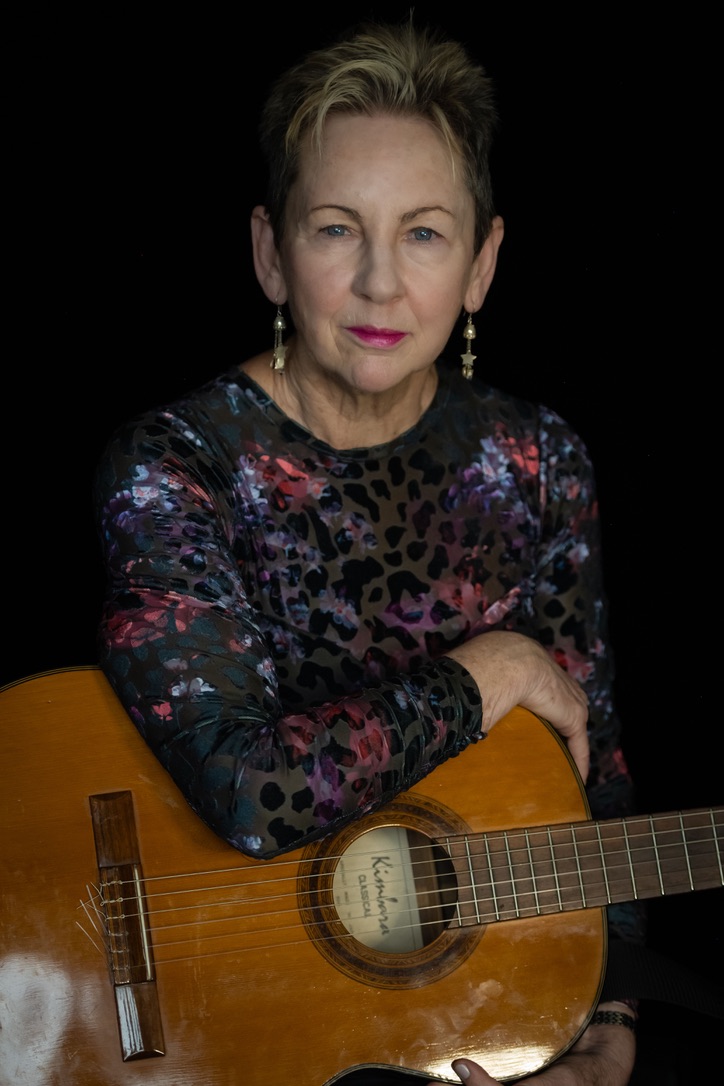 Portrait of Jill Dawson holding her classical guitar